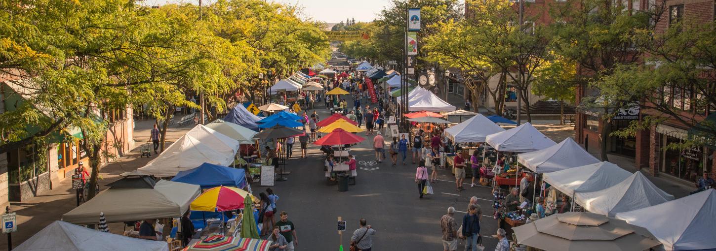 Merchants' booths and stalls line Main Street Moscow on an early Saturday morning for the Farmers Market.